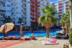 a swimming pool with people in a resort at Flat in Shëngjin Beachfront Getaway in Shëngjin