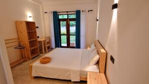 a small room with a bed and a window at Cozy place in Ahangama