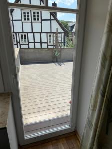 an open door to a balcony with a deck at Hugo zwei in Warburg