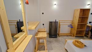a room with wooden furniture and a room with a refrigerator at Cozy place in Ahangama