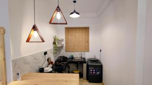 a kitchen with a table and a sink in a room at Cozy place in Ahangama