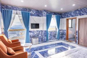 a bedroom with a blue tiled wall with a window at Sun Heaven Dalat in Xuân Trường