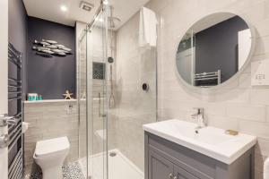 a bathroom with a toilet and a sink and a shower at Edward Cottage - Old Town Poole Home, Moments from Poole Quay in Poole
