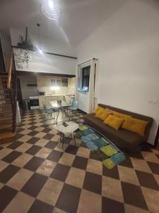 a living room with a couch and a checkered floor at Holiday loft U Kotynku in Veselí nad Lužnicí