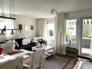 a living room with a couch and a table at FeWo Parkblick mit 2 Bädern in Bad Harzburg