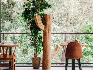 a room with two tables and a large window at HEJMO Hostel in Hossegor