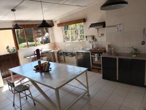 a kitchen with a table in the middle of it at Crocodile Rock Lodge in Bulawayo
