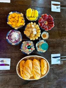 a wooden table topped with different types of fruit at Mekong Rustic Can Tho Hideaway in Can Tho
