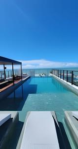 a rendering of a swimming pool with the ocean in the background at Get One - João Pessoa in João Pessoa