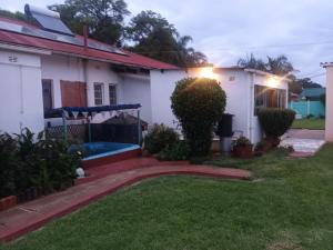 a backyard of a house with a garden at Crocodile Rock Lodge in Bulawayo