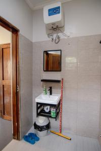 a bathroom with a sink and a mirror at Open Gate House in Arusha