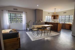 a dining room and kitchen with a table and chairs at Open Gate House in Arusha