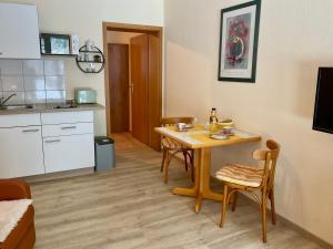 a small kitchen with a table and chairs in a room at Kleine Oase 46 in Funfseen +6 photos