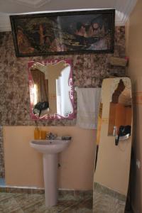 a bathroom with a sink and a mirror at Sun & Sea house in Agadir