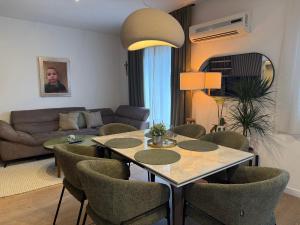 a living room with a table and chairs and a couch at Villa Volga in Jelsa
