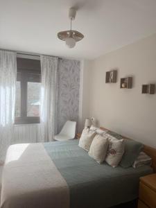 a bedroom with a bed and a ceiling fan at La Terraza de Sovega in Arenas de Cabrales