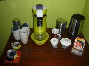 a yellow coffee maker sitting on top of a wooden table at B&B Wiezebed in Wieze +25 photos