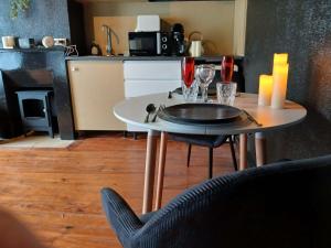a table with wine glasses on it in a kitchen at la penombre spa in Abbeville