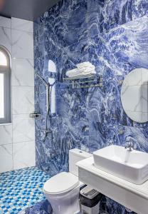 a blue and white bathroom with a toilet and a sink at Sun Heaven Dalat in Xuân Trường +132 photos