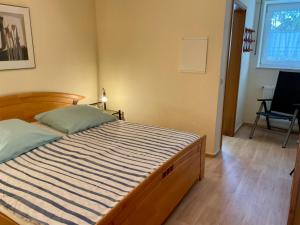 a bedroom with a large bed with a striped mattress at Kleine Oase 46 in Funfseen