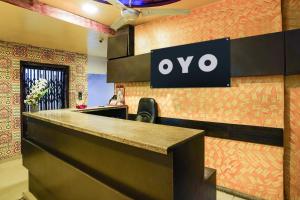an office with an ovo sign on a wall at Hotel O Crystal in Ahmedabad
