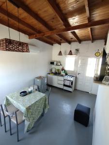 a kitchen with a table and chairs in a room at Casa Saavedra in Dolores