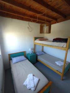 two beds in a room with a bunk bed at Casa Saavedra in Dolores
