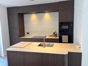 a kitchen with a sink and a counter top at Pirate, op 100 meter van strand in Koksijde