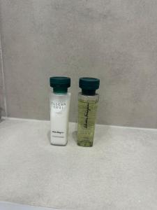 two bottles of medicine sitting on a counter at Toplage beim Rathaus Grace Royal Designsuite in Vienna