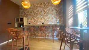 a bar with chairs and tables in a room at Marina Boutique in Valencia