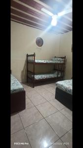 a room with two beds and a basketball on the wall at Casa 02 Cantinho e Sossego in Vespasiano