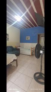 a room with two beds and a fan in it at Casa 02 Cantinho e Sossego in Vespasiano
