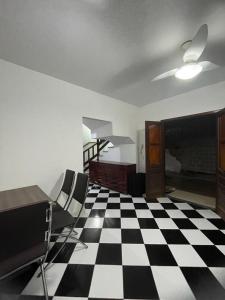 a room with a black and white checkered floor at CAIPORA Hostel Lagoa in Saquarema