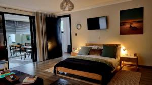 a bedroom with a bed and a tv on the wall at Stay at 64 Omeya in Windhoek
