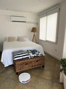 a bedroom with a bed and a window at Blue House in San Pedro