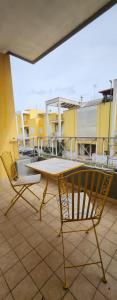 a table and two chairs on a balcony at La Casa delle Liane in Galatina