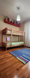 a room with two bunk beds and a rug at La Casa delle Liane in Galatina