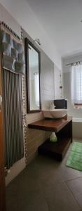 a bathroom with a sink and a mirror at La Casa delle Liane in Galatina +20 photos