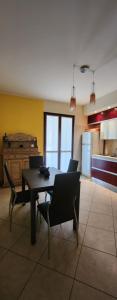 a kitchen with a table and chairs in a room at La Casa delle Liane in Galatina