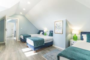 a bedroom with two beds and a staircase at Casa da Horta by Atlantic Holiday in Santa Cruz