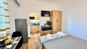a room with a bed and a table with a bowl of fruit at Elina's Rooms in Poros