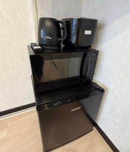 a coffeemaker with a coffee maker on top of it at SnowMapleHouse西川口 in Kawaguchi
