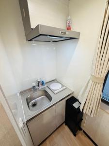 a small kitchen with a sink and a stove at SnowMapleHouse西川口 in Kawaguchi +15 photos