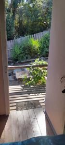 an open door to a garden with a fence at Cabaña La Isla in Isla Negra +1 photo