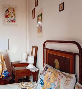 a bedroom with a bed and a table with a lamp at Casetta dei Nonni in Vitorchiano