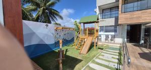 a playground in a building with a slide at Studio Mare Alta in Tamandaré