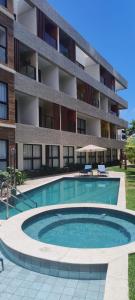 a swimming pool in front of a building at Studio Mare Alta in Tamandaré +16 photos
