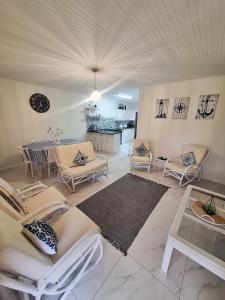 a living room with couches and a dining room at The Oyster Cove in Brenton-on-Sea