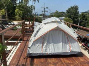 a tent sitting on top of a wooden deck at Bird Nest in Ko Tao