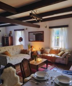 a living room with a couch and a table at Mazurska Chata Rydzewo in Rydzewo
